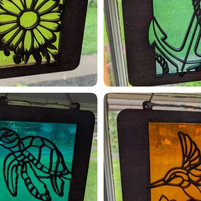 Suncatchers in a window: sunflower, sea turtle, hummingbird